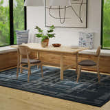 Dining room with a blue and ivory Rizzy BX05BL area rug, wood table, and built-in bench seating by a large window. Roomscene-Rectangle