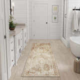 Bright bathroom with white cabinets and a Nourison Astra Rust Vintage runner rug on light wood floors.