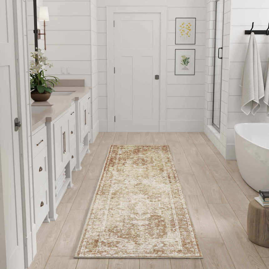 Bright bathroom with white cabinets and a Nourison Astra Rust Vintage runner rug on light wood floors.