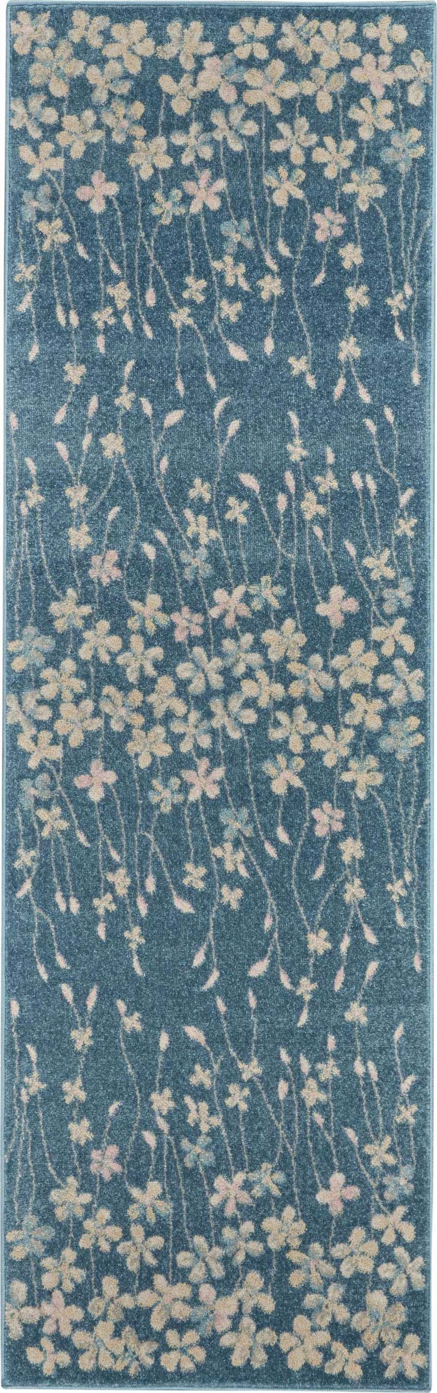 Close-up of the Nourison Tranquil Turquoise rug. Aqua rug with a floral pattern in cream, pink, and blue. Contemporary style.