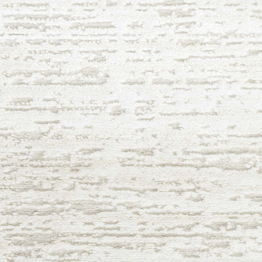Close-up of the Nourison Dew Ivory Beige rug showing its low pile texture and chestnut-colored, modern design.