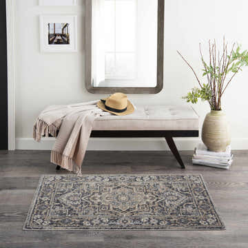 Entryway with bench and Nourison Moroccan Celebration Navy Vintage Area Rug on wood floor.