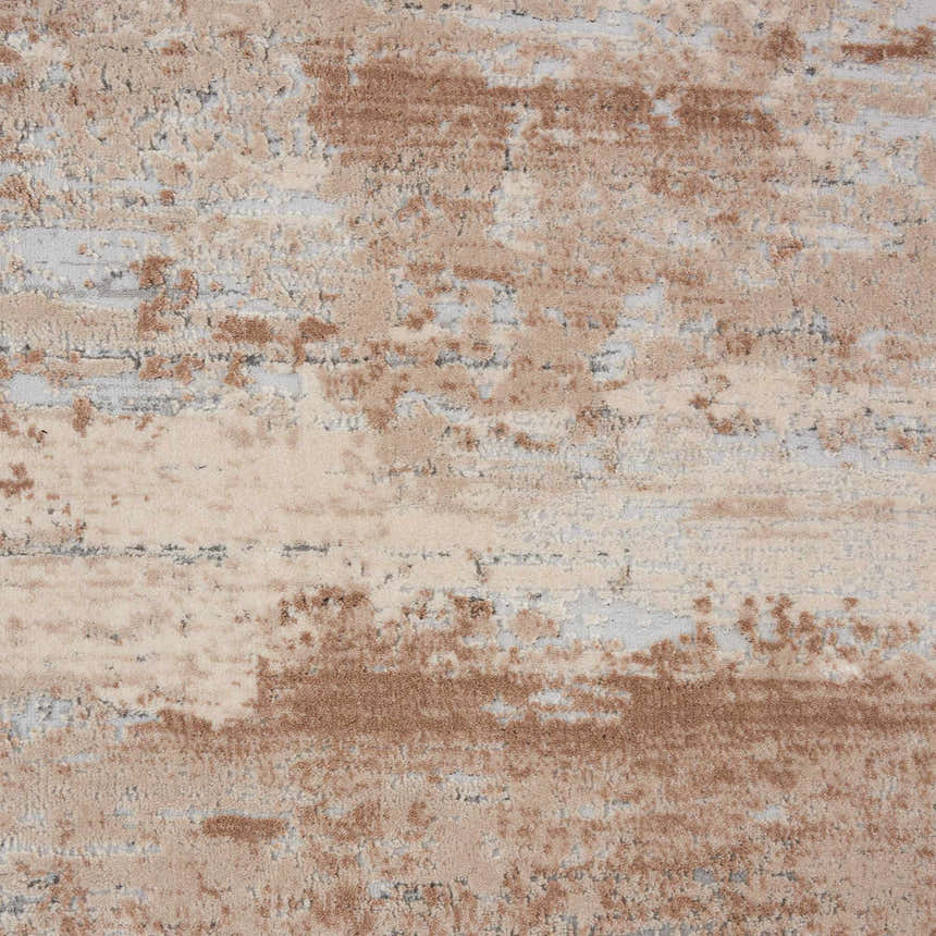 Close-up of the Nourison Rustic Textures Beige Area Rug, showing its abstract pattern and soft, neutral colors.