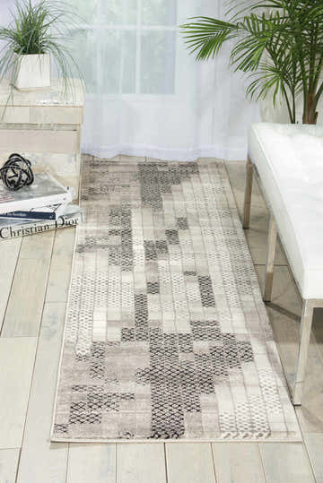 Hallway scene with a Nourison Soho Grey runner rug, white bench, and plants for a modern, airy look.