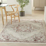 Farmhouse dining room with Nourison Carina Brick Silver rug, wood table, woven chair, and light wood floors.