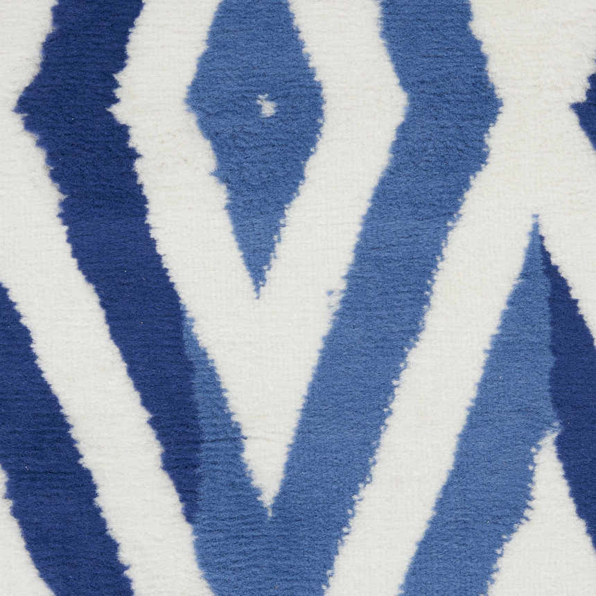 Close-up of Nourison Whimsicle Ivory Blue rug showing the modern geometric pattern and soft, textured polypropylene fibers.