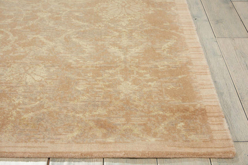 Close up of the Sand Nourison Silken Allure rug showing sandstone color and subtle floral design.