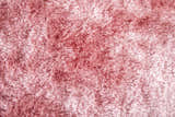 Close-up of the plush Feizy Indochine Modern Solid Textured Blush Swatch rug; a pink, hand-tufted polyester rug. Texture