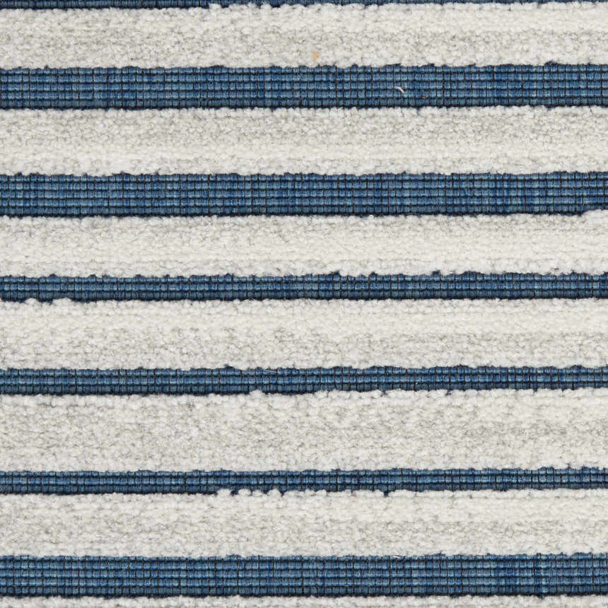 Close-up of the Nourison Key Largo Blue rug. Features a contemporary striped pattern in light blue and white.