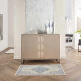 Living room scene with a Nourison Grafix Ivory Pink Vintage rug on a herringbone floor. Modern cabinet and decor.