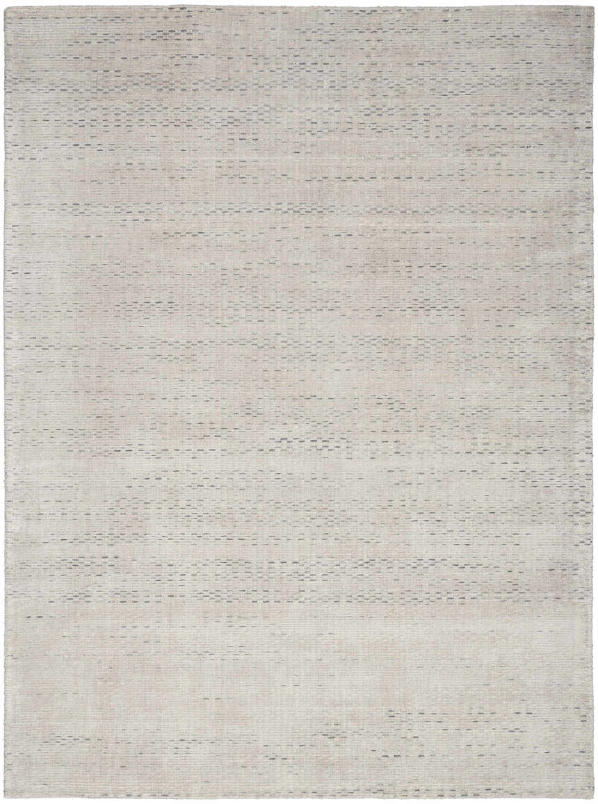 Close-up of the handmade Calvin Klein Valley Silver rug. Features a subtle gray, mid-century modern design.