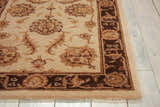 Close-up of the beige Nourison Heritage Hall Freeform Persian rug, showing floral patterns and dark brown border.