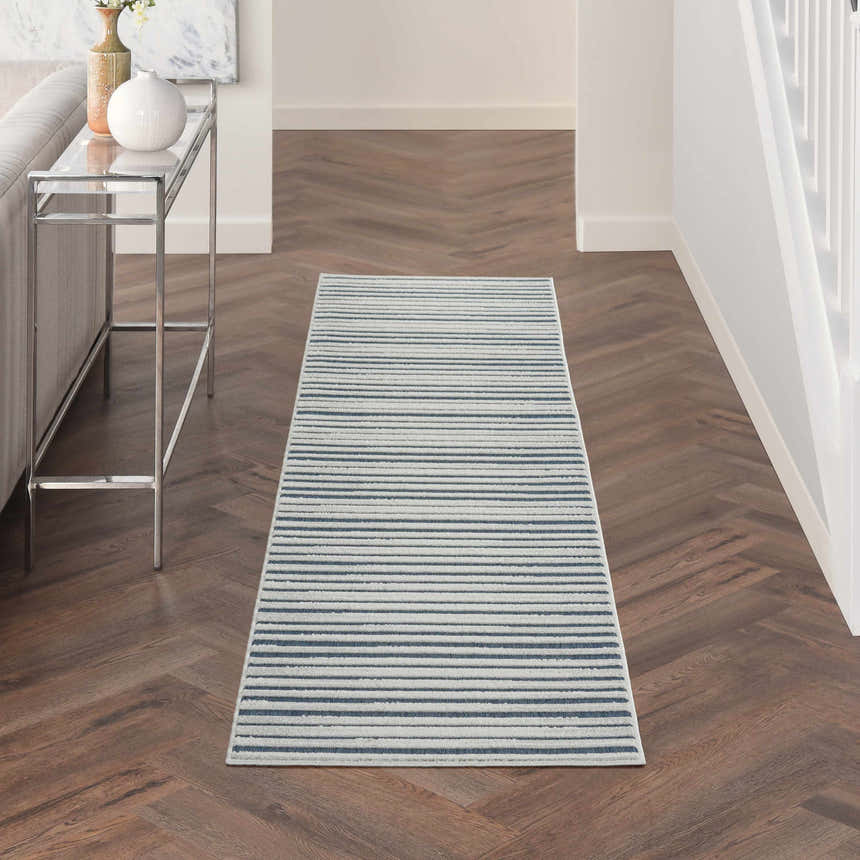 Hallway scene with a Nourison Key Largo Blue rug. Contemporary style with light blue stripes on wood floors.