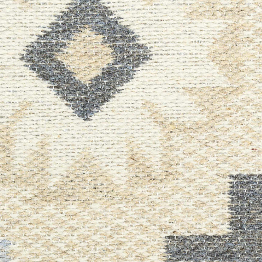 Close-up of the Nourison Copenhagen Ivory Navy rug showing its woven texture and diamond pattern in chestnut, ivory, and navy.