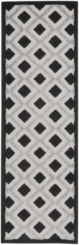 Close-up of Nourison Aloha Black White Modern Area Rug; geometric diamond pattern in black and white.