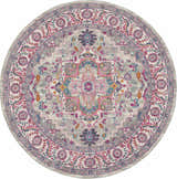 Close-up of round Nourison Passion Light Grey Pink rug. Bohemian style with floral and geometric patterns in pink, gray, and blue.