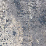 Close-up of the Nourison Rustic Textures Grey Beige rug, showing its distressed, modern pattern and soft, textured pile.