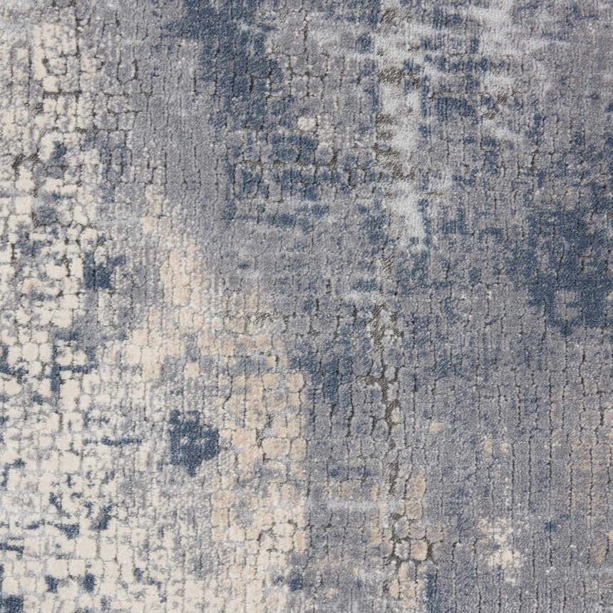 Close-up of the Nourison Rustic Textures Grey Beige rug, showing its distressed, modern pattern and soft, textured pile.