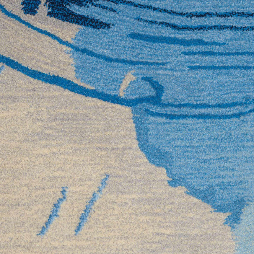 Close-up of the Nourison Symmetry Blue Ivory rug showing its abstract pattern and soft polyester texture.