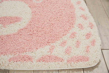 Close-up of the Nourison Hudson Freeform Pink Kids Rug, featuring a playful pink and white pattern, soft texture, and durable construction.