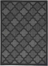 Close-up of the Nourison Easy Care Charcoal Black Modern Area Rug with a taupe quatrefoil pattern.