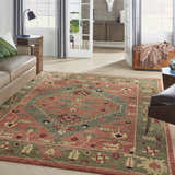 Living room scene with a Nourison Tahoe Rust rug, leather sofa, and light wood floors.