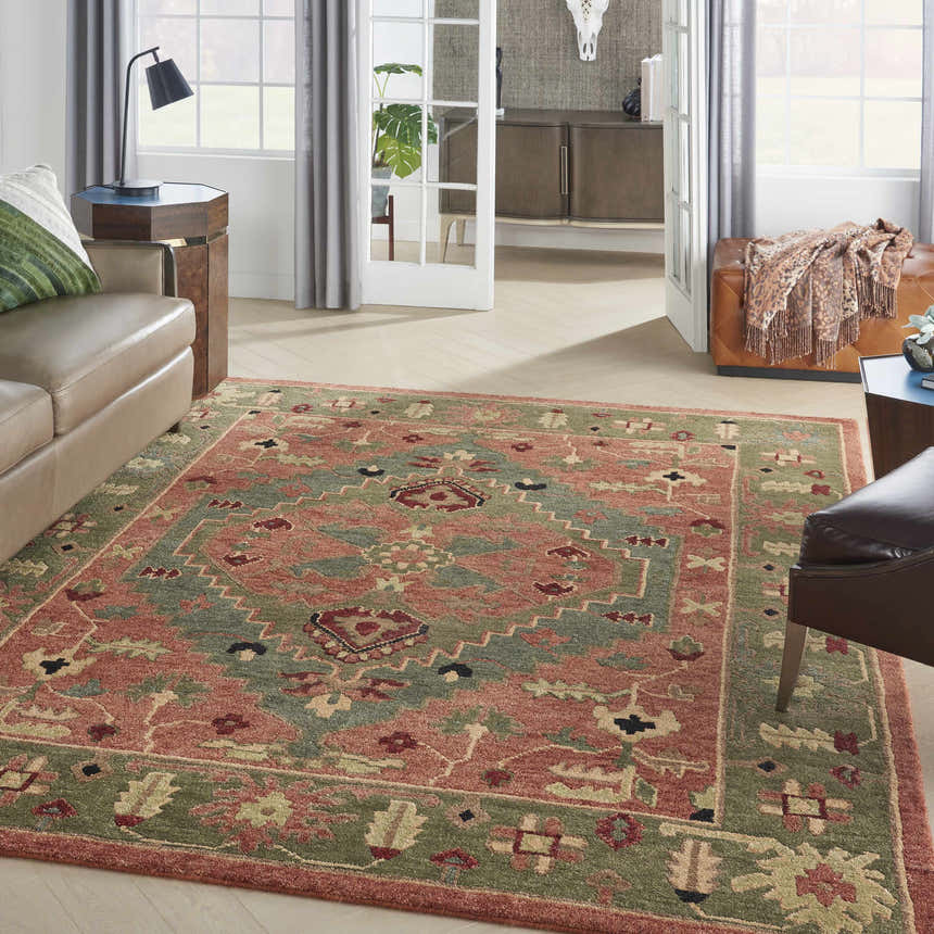 Living room scene with a Nourison Tahoe Rust rug, leather sofa, and light wood floors.