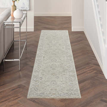 Hallway with Nourison Infinite Light Grey Vintage runner rug on dark wood floor. Modern console table.
