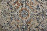 Close-up of the Feizy Kaia rug. Transitional damask pattern in tan, blue, and orange hues. Vintage style rug texture. Texture