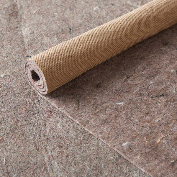 Close-up of the Nourison Loc Non-slip Pad Area Rug in silver gray, showing its texture and rolled form.