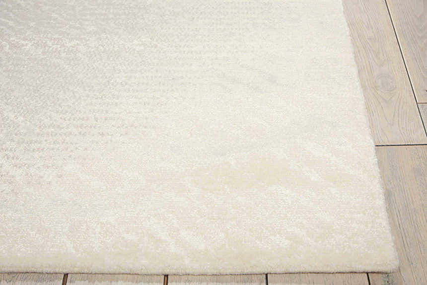 Close-up of the ivory and grey Nourison Twilight rug showing its subtle pattern and soft texture on light wood flooring.