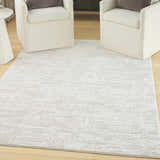 Living room scene with two chairs on Nourison Dew Ivory Beige rug.
