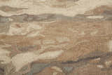 Close-up of the Feizy Amira rug showing its abstract brown, gray, and tan pattern and hand-tufted wool texture. Texture