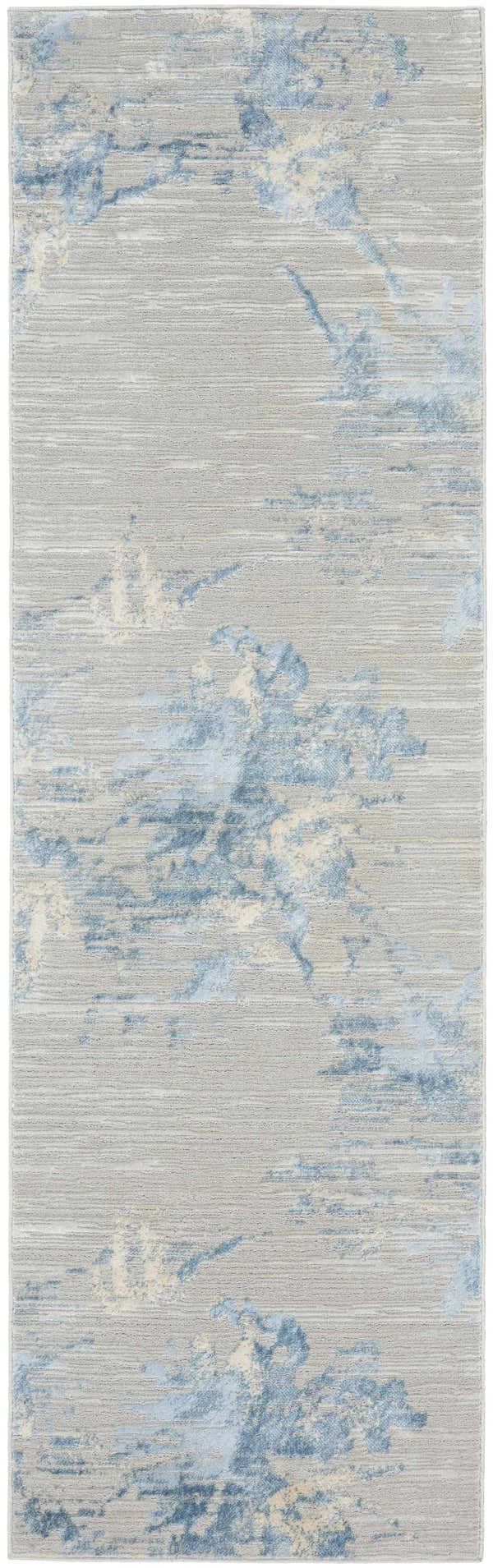 Close-up of Calvin Klein CK005 Enchanting Grey Sky rug. Contemporary high-pile rug with blue and beige abstract pattern.