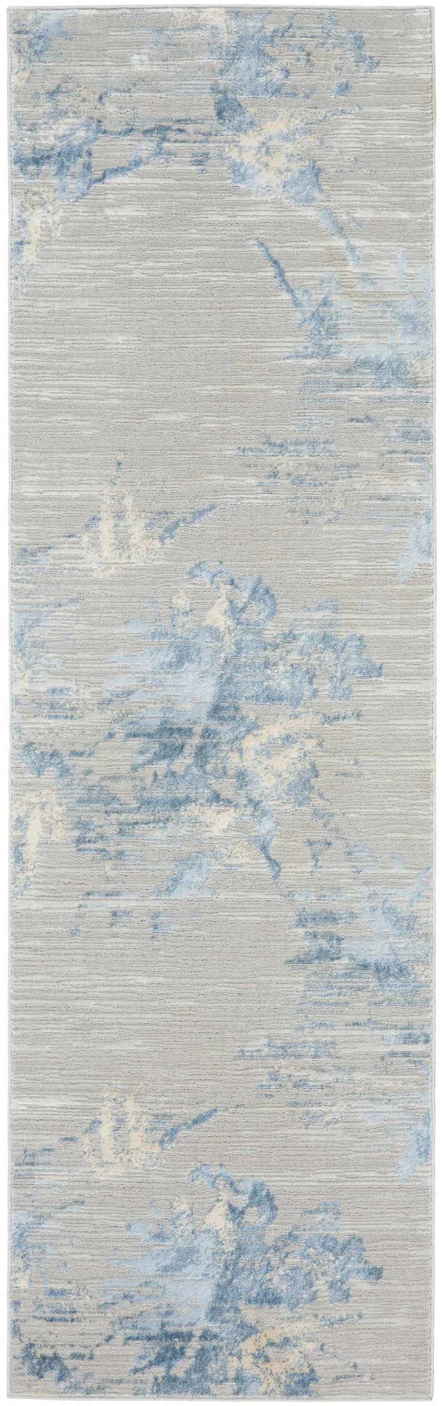 Close-up of Calvin Klein CK005 Enchanting Grey Sky rug. Contemporary high-pile rug with blue and beige abstract pattern.
