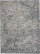 Close-up of Nourison Rustic Textures Light Grey Blue rug. Modern design with gray, blue, and subtle rust-colored accents.