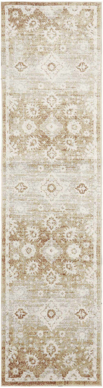 Close-up of Nourison Astra Copper Vintage rug. Caramel and cream tones with a distressed floral pattern. Machine-made texture.
