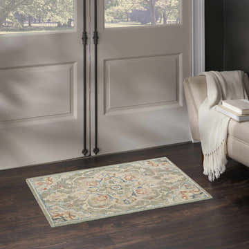 Entryway with Nourison Maison Green Ivory Vintage Indoor Area Rug, dark wood floors, and neutral armchair.