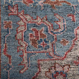 Close-up of the hand-knotted Rizzy CET723 area rug. Features a traditional pattern in beige, blue, dark red, and ivory wool. Texture