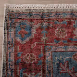 Close up of the hand knotted Rizzy CET723 area rug. Features a traditional design with beige, blue, dark red, and ivory hues. Corner