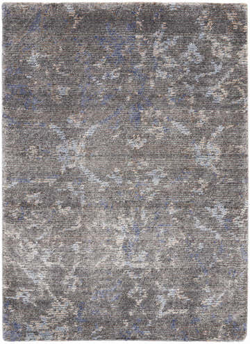 Close-up of the Nourison Lucent Coal Vintage Area Rug. Dark brown with subtle blue and beige accents, handmade texture.