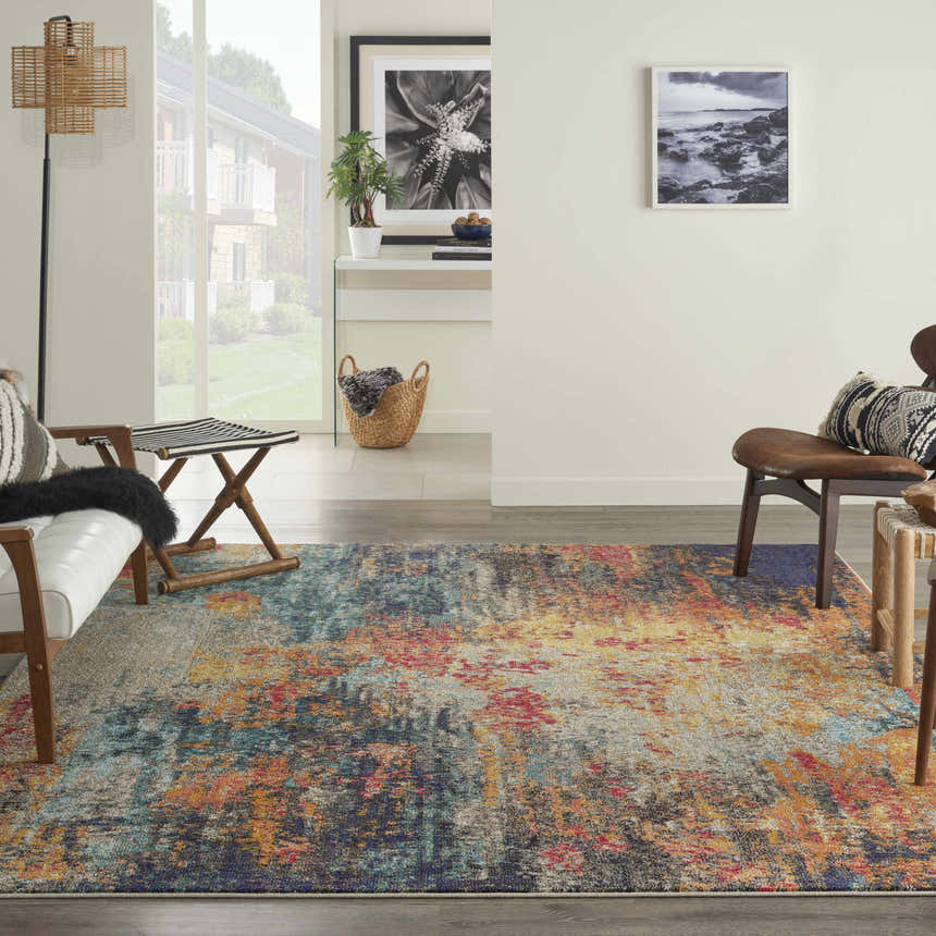 Living room scene with a Nourison Celestial Multicolor rug, white sofa, and mid-century modern decor.