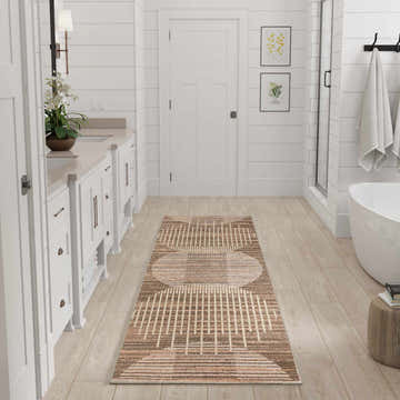 Bright bathroom with a Latte Nourison Astra rug, white cabinets, and wood floors. Mid-century modern style.