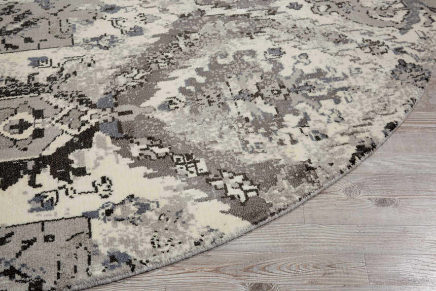Close-up of the round Nourison Twilight Ivory Grey Vintage rug showing the chestnut, grey, and white vintage pattern.