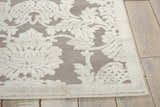 Close-up of the gray Nourison Graphic Illusions Nickel Vintage rug with a white floral pattern and runner shape.