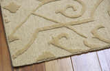 Close-up of the Nourison Ambrose Straw Indoor Area Rug, a tan wool rug with a raised geometric and floral design.