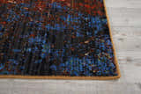 Close up of the Nourison Chroma Red Flare rug, featuring a modern abstract design in red, blue, and brown hues.