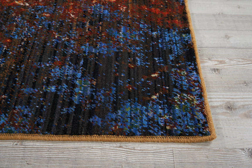 Close up of the Nourison Chroma Red Flare rug, featuring a modern abstract design in red, blue, and brown hues.