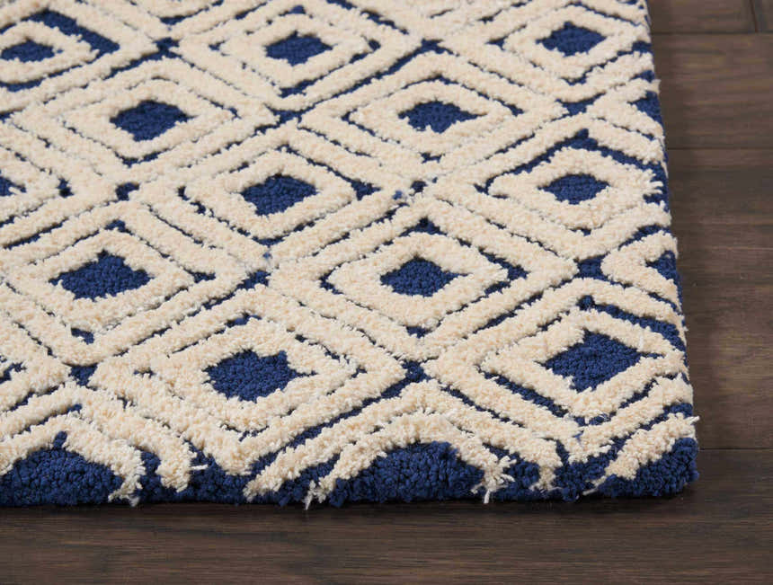 Close-up of the Nourison Deco Mod Navy Ivory rug, featuring a geometric diamond pattern and textured shag pile.