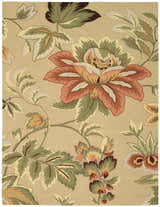 Close-up of the Nourison Fantasy Beige rug featuring a large floral pattern with green leaves and a beige background.